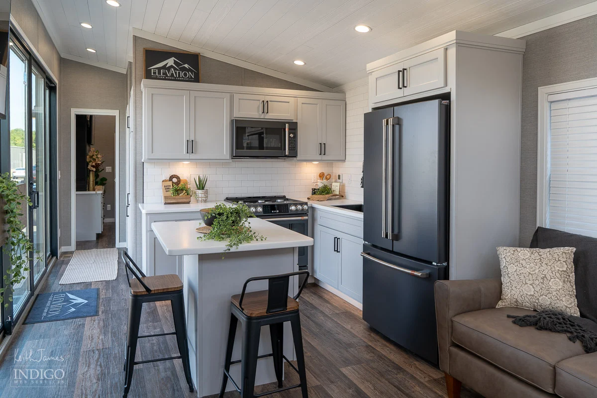 Sales brochure photo of the kitchen and dining area of a park model RV.