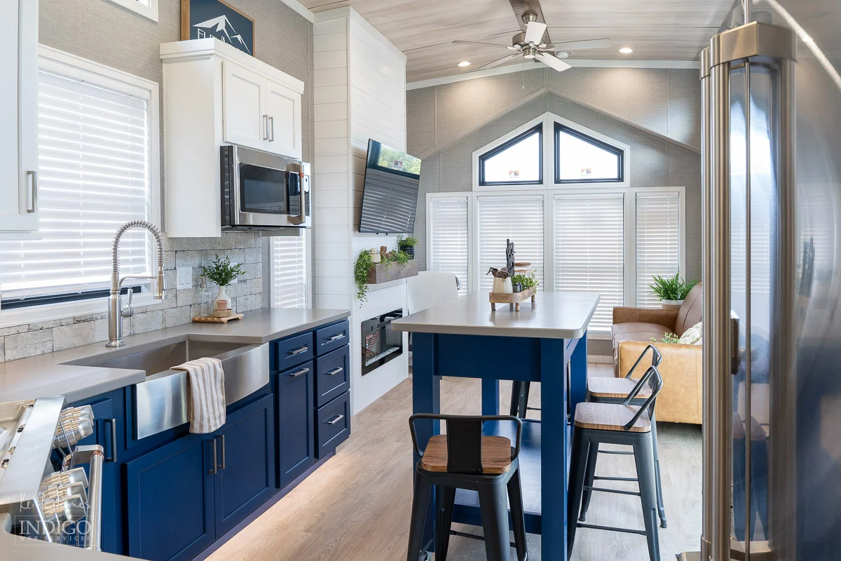 Sales brochure photo of the kitchen and dining area of a park model RV.