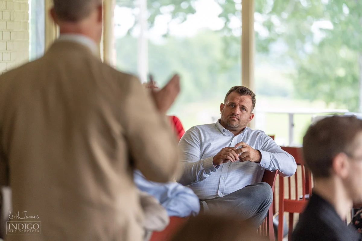 New York Life Agent Cory Wahl listens as US Congressman Mark Messmer briefs the Spencer County Regional Chamber of Commerce.
